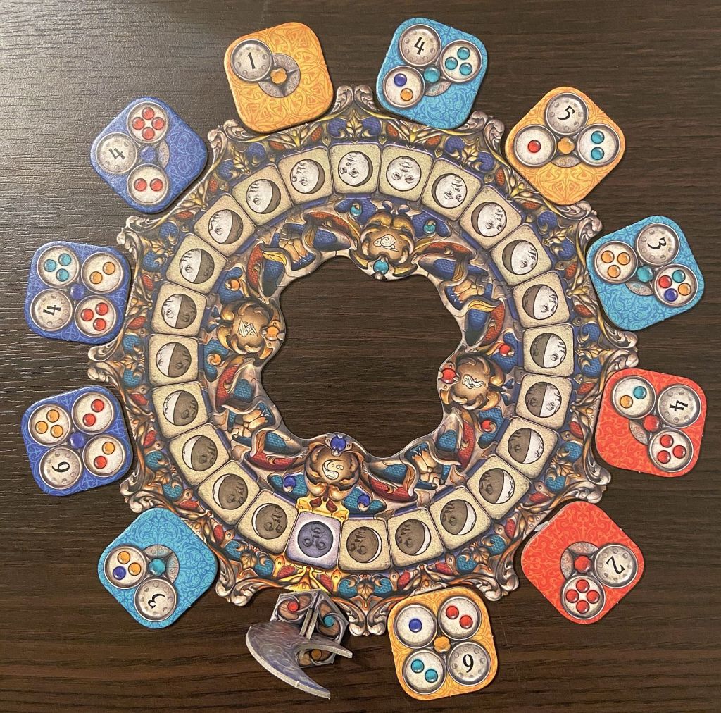 The main element of the game is a circle depicting moon phases. You move Moon around it by 1, 2 or 3 tiles and choose which one you will take.